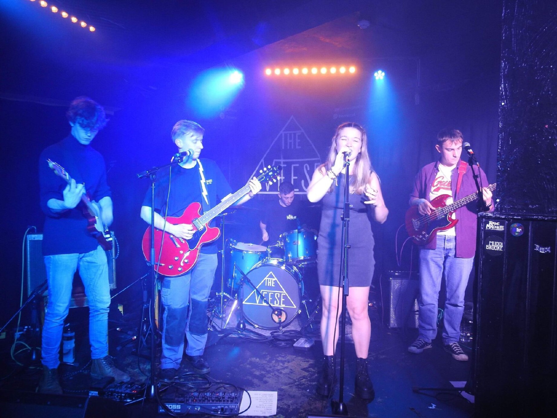 Glass Half Spilt playing live under blue stage lights