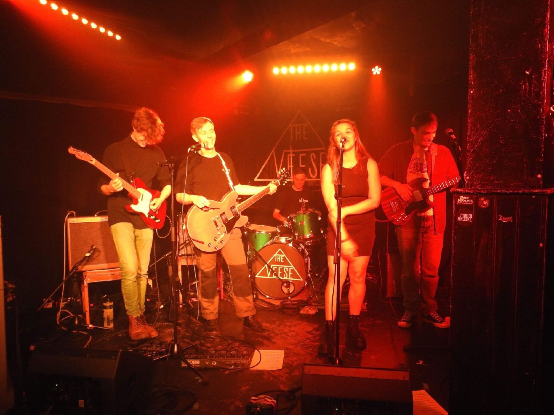 Glass Half Spilt playing live under red stage lights